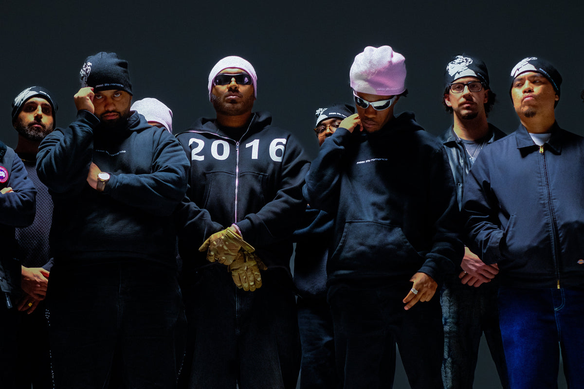 Group of people wearing past life romance sameer amir merch clothing and beanies against a black background